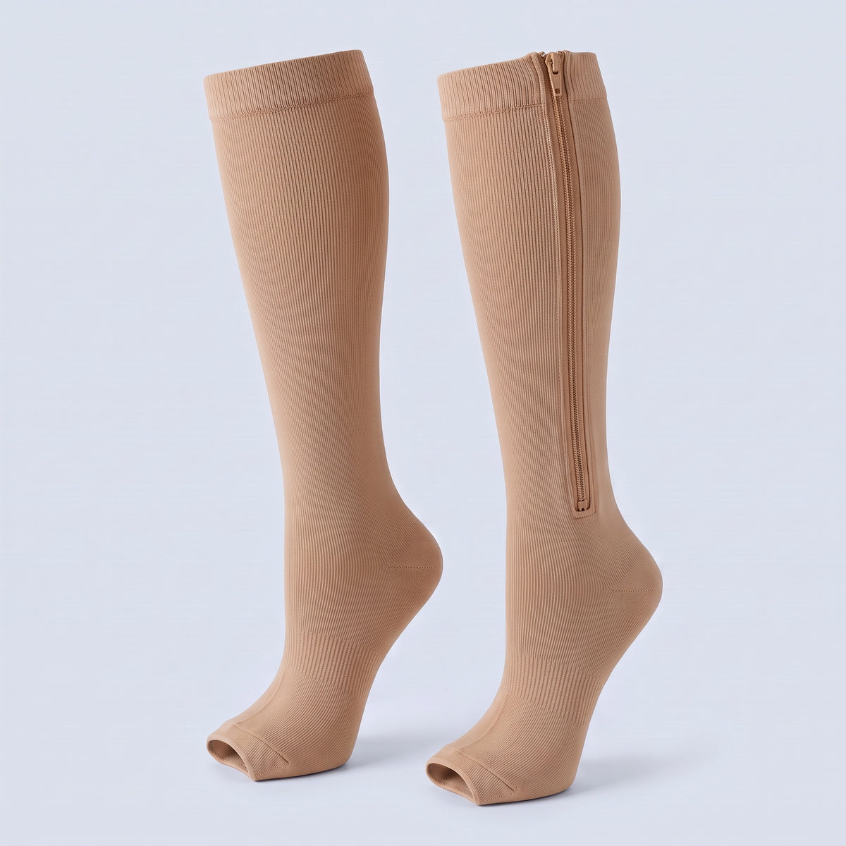 Beige compressiekousen met rits die van de boord tot vlak boven de enkel loopt, open teen
