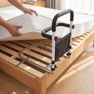 Een hand tilt het matras op, het frame van de bedbeugel ligt op de lattenbodem